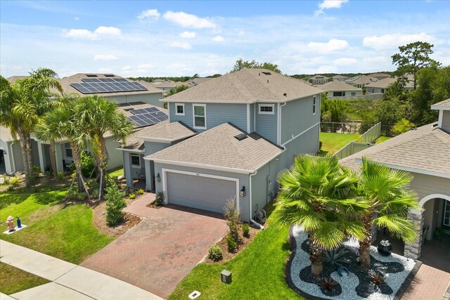 922 Grazie Loop, Davenport, FL 33837 - view of front of property featuring roof with shingles, an attached garage, decorative driveway, a residential view, and stucco siding