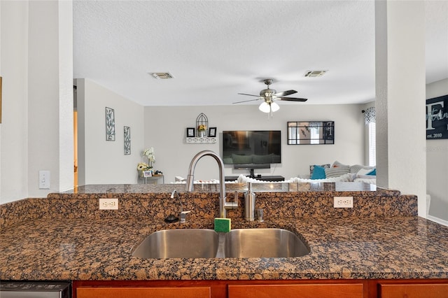 1224 Blackwater Pond Dr, Orlando, FL 32828 - kitchen with a ceiling fan, open floor plan, dark stone countertops, and a textured ceiling