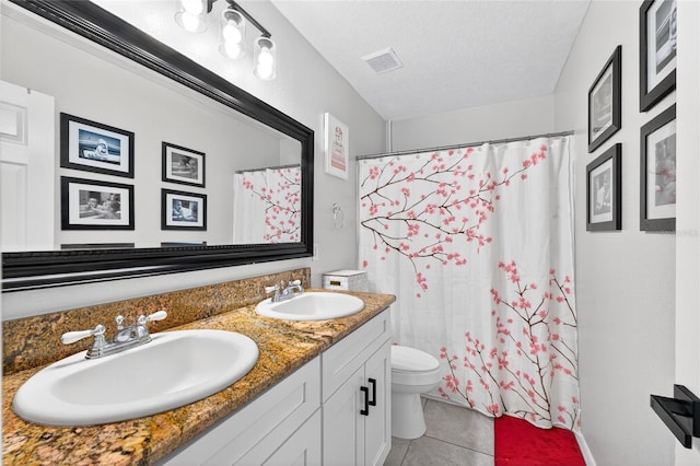 1224 Blackwater Pond Dr, Orlando, FL 32828 - bathroom featuring double vanity, tile patterned flooring, a textured ceiling, and a shower with curtain