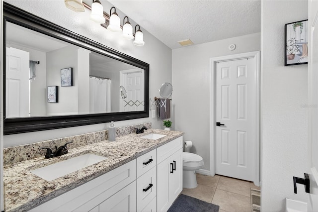 1224 Blackwater Pond Dr, Orlando, FL 32828 - bathroom featuring tile patterned floors, double vanity, and a textured ceiling