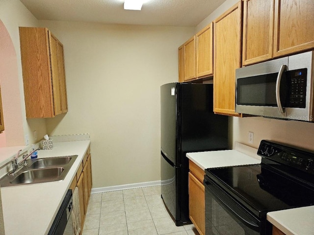 6214 Stevenson Dr Unit 208, Orlando, FL 32835 - kitchen featuring black appliances, light countertops, and light tile patterned floors
