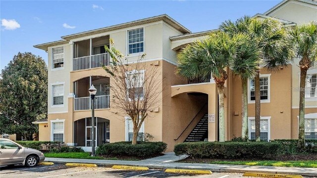 6214 Stevenson Dr Unit 208, Orlando, FL 32835 - view of building exterior featuring uncovered parking