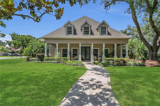 19554 Spring Oak Dr, Eustis, FL 32736 - new england style home featuring a shingled roof, a front yard, and stucco siding
