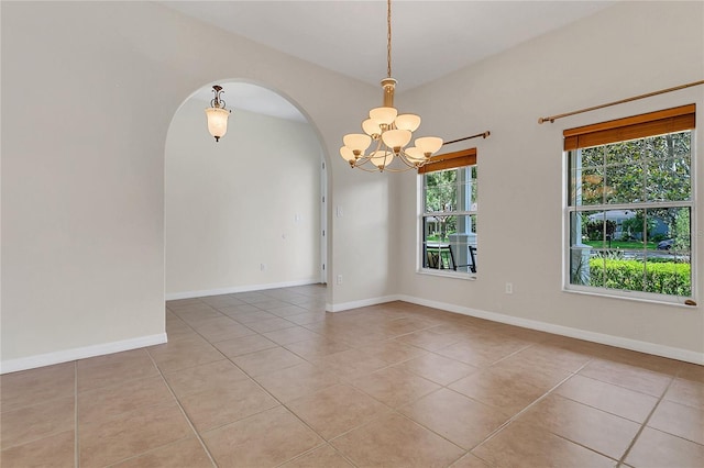 19554 Spring Oak Dr, Eustis, FL 32736 - unfurnished room featuring a chandelier, arched walkways, and light tile patterned flooring