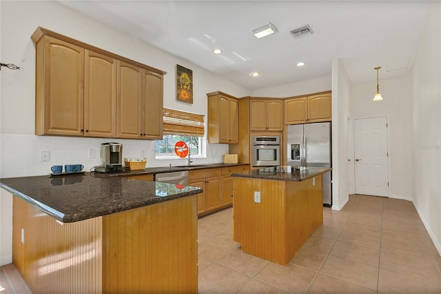19554 Spring Oak Dr, Eustis, FL 32736 - kitchen featuring stainless steel appliances, a peninsula, dark stone countertops, light tile patterned flooring, and recessed lighting