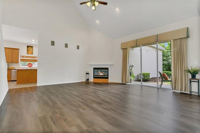 19554 Spring Oak Dr, Eustis, FL 32736 - unfurnished living room with high vaulted ceiling, ceiling fan, wood finished floors, a glass covered fireplace, and recessed lighting