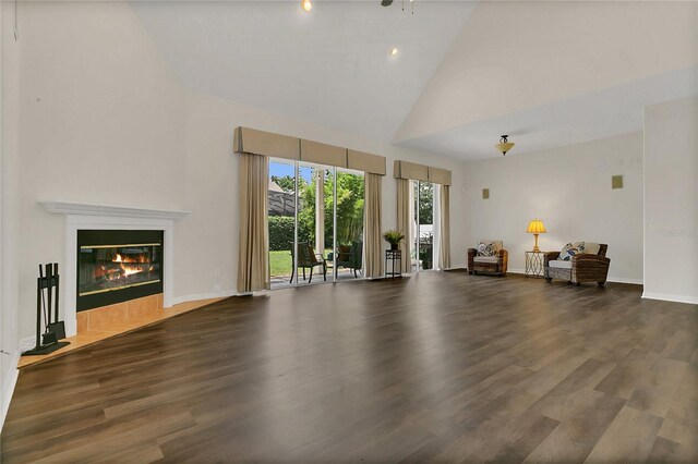 19554 Spring Oak Dr, Eustis, FL 32736 - living room with high vaulted ceiling, wood finished floors, and a tiled fireplace