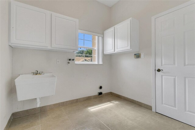 19554 Spring Oak Dr, Eustis, FL 32736 - washroom featuring cabinet space and light tile patterned flooring