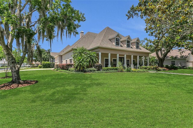 19554 Spring Oak Dr, Eustis, FL 32736 - view of property exterior with a yard, a chimney, and a porch