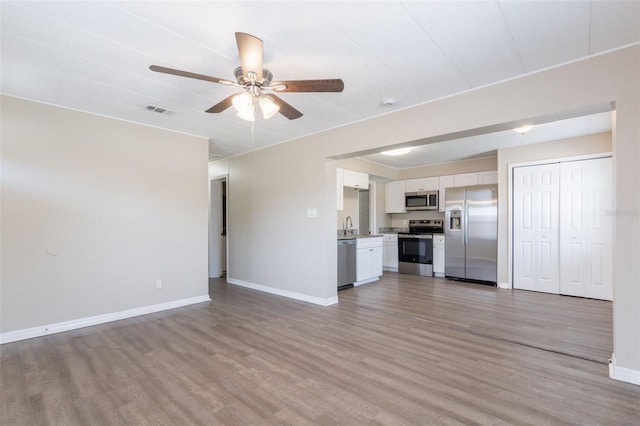 3850 11th Ave S, Saint Petersburg, FL 33711 - unfurnished living room featuring light wood-style floors and ceiling fan