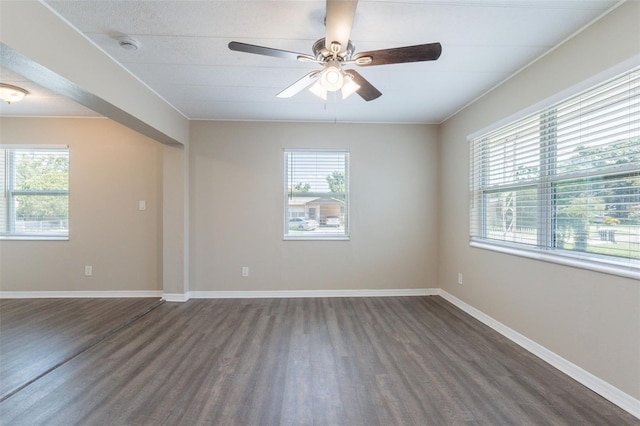 3850 11th Ave S, Saint Petersburg, FL 33711 - unfurnished room with dark wood-style floors, plenty of natural light, a ceiling fan, and a smoke detector