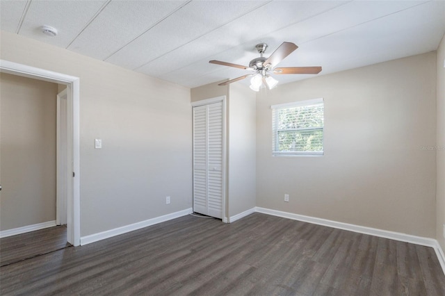 3850 11th Ave S, Saint Petersburg, FL 33711 - unfurnished bedroom featuring dark wood-style floors, a closet, and ceiling fan
