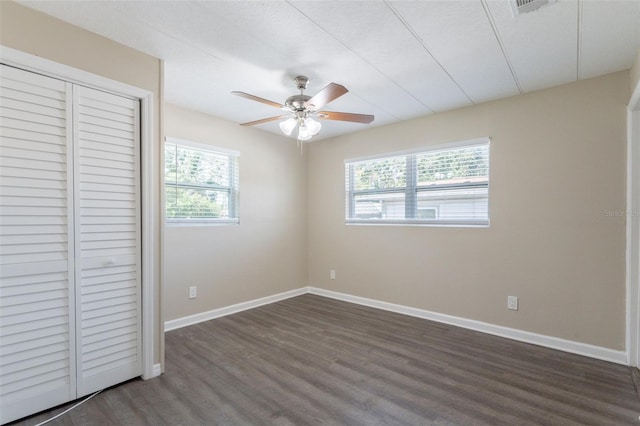 3850 11th Ave S, Saint Petersburg, FL 33711 - unfurnished bedroom with a closet, dark wood-style flooring, and ceiling fan