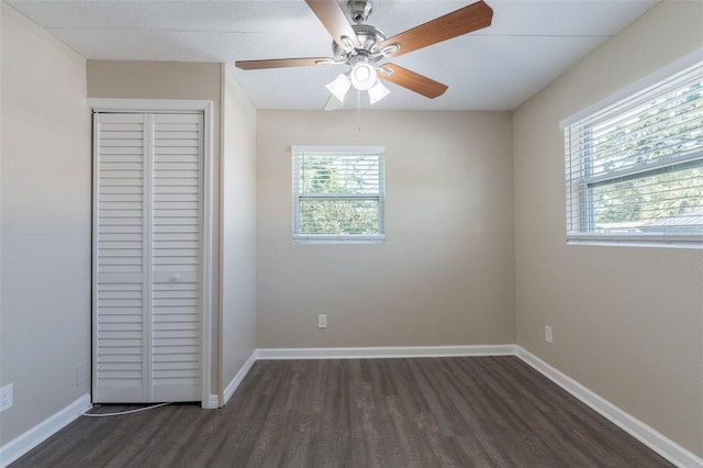 3850 11th Ave S, Saint Petersburg, FL 33711 - unfurnished bedroom featuring dark wood-style floors, a closet, and ceiling fan