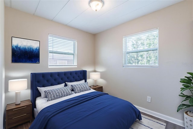 3850 11th Ave S, Saint Petersburg, FL 33711 - bedroom with multiple windows, a baseboard heating unit, and wood finished floors