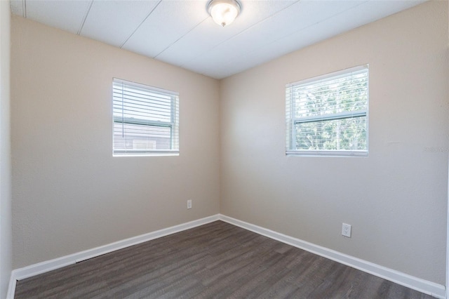 3850 11th Ave S, Saint Petersburg, FL 33711 - spare room featuring dark wood-style floors and baseboards