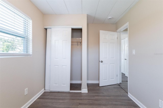 3850 11th Ave S, Saint Petersburg, FL 33711 - unfurnished bedroom featuring dark wood-style flooring and a closet