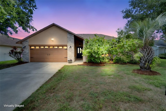 2406 Sweetwater Blvd, Saint Cloud, FL 34772 - view of front of property featuring stucco siding, an attached garage, driveway, and a lawn