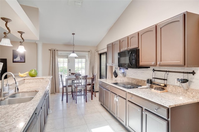 2406 Sweetwater Blvd, Saint Cloud, FL 34772 - kitchen with black appliances, lofted ceiling, backsplash, light tile patterned floors, and pendant lighting