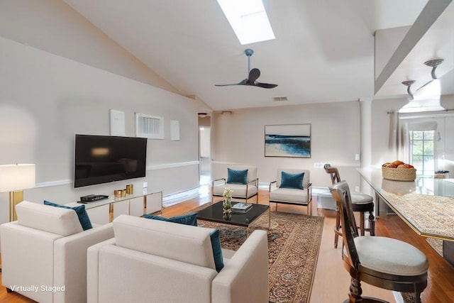 2406 Sweetwater Blvd, Saint Cloud, FL 34772 - living room featuring wood finished floors, vaulted ceiling, a skylight, and ceiling fan