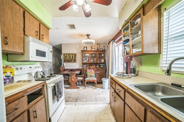 6401 Fortune Ln, Apopka, FL 32712 - kitchen featuring white appliances, ceiling fan, light countertops, light flooring, and a textured ceiling