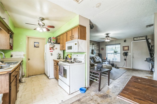 6401 Fortune Ln, Apopka, FL 32712 - kitchen featuring white appliances, ceiling fan, brown cabinetry, light countertops, and a textured ceiling