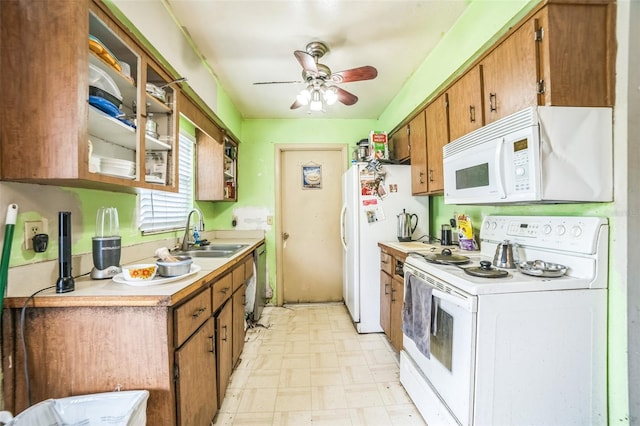 6401 Fortune Ln, Apopka, FL 32712 - kitchen with white appliances, light floors, light countertops, ceiling fan, and brown cabinets