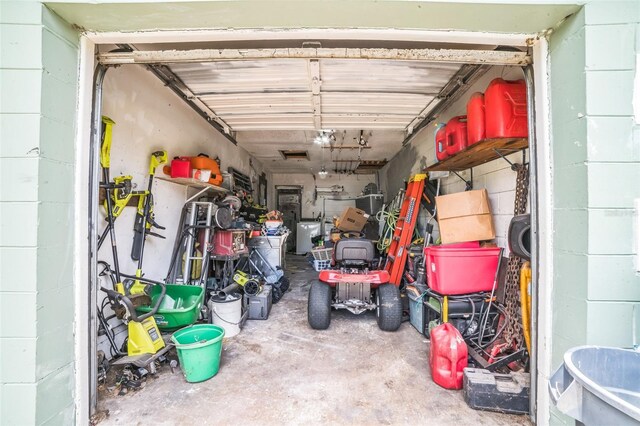 6401 Fortune Ln, Apopka, FL 32712 - garage featuring a garage door opener and concrete block wall