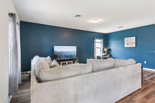 785 Orchid Grove Blvd, Davenport, FL 33837 - living area featuring dark wood-style flooring and baseboards
