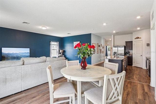 785 Orchid Grove Blvd, Davenport, FL 33837 - dining area featuring dark wood-style floors and recessed lighting