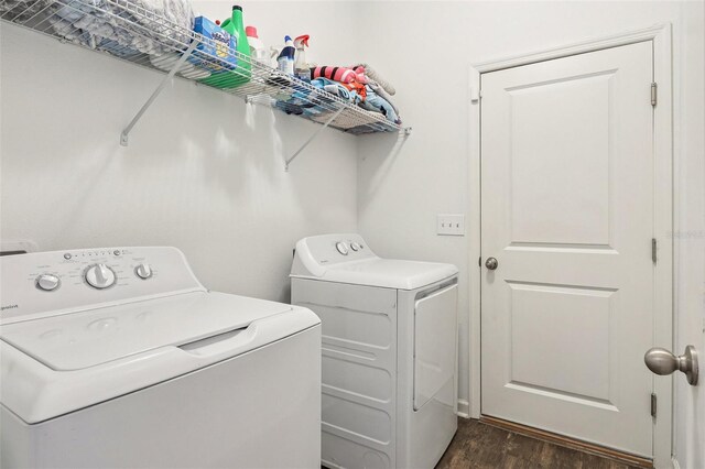 785 Orchid Grove Blvd, Davenport, FL 33837 - laundry room featuring washing machine and dryer and dark wood-type flooring