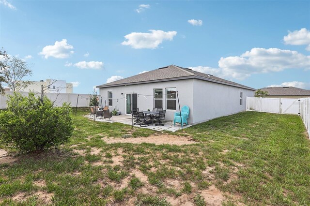 785 Orchid Grove Blvd, Davenport, FL 33837 - rear view of house featuring a patio, a fenced backyard, roof with shingles, stucco siding, and a gate