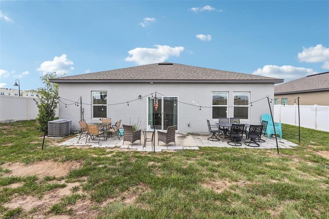 785 Orchid Grove Blvd, Davenport, FL 33837 - back of house with a fenced backyard, stucco siding, a patio, and roof with shingles
