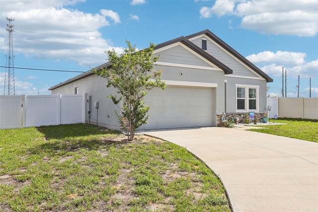 785 Orchid Grove Blvd, Davenport, FL 33837 - view of front of property with a garage, concrete driveway, stone siding, and stucco siding