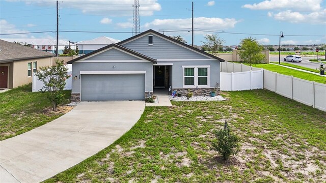 785 Orchid Grove Blvd, Davenport, FL 33837 - ranch-style home with an attached garage, concrete driveway, stone siding, and stucco siding