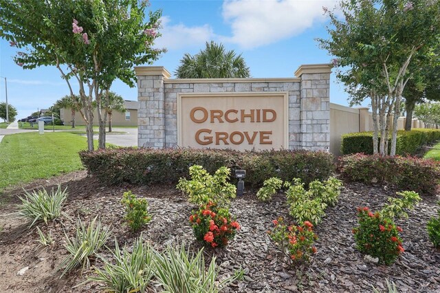 785 Orchid Grove Blvd, Davenport, FL 33837 - community / neighborhood sign featuring a lawn