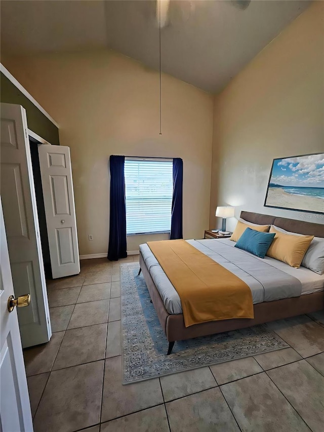 2817 Moultrie Creek Dr, Kissimmee, FL 34743 - tiled bedroom featuring high vaulted ceiling and baseboards