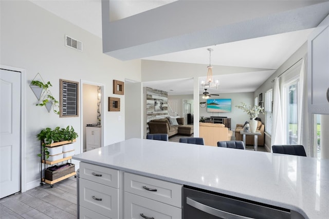 4478 Yachtmans Ct, Orlando, FL 32812 - kitchen featuring dishwasher, white cabinetry, light wood-type flooring, pendant lighting, and light stone countertops