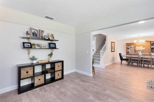 4478 Yachtmans Ct, Orlando, FL 32812 - dining space with stairway, a chandelier, and wood finished floors