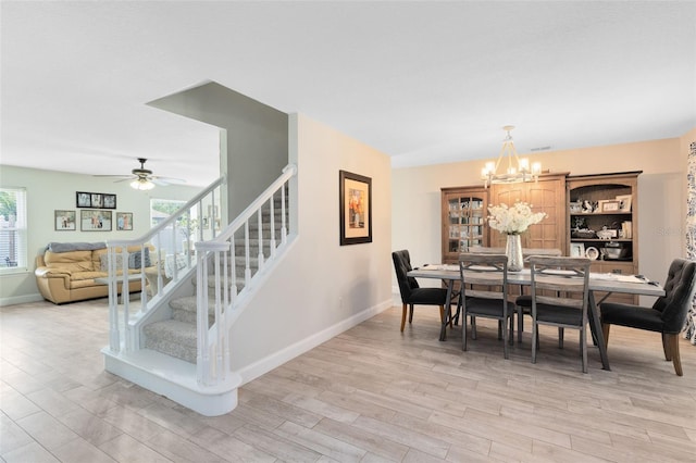 4478 Yachtmans Ct, Orlando, FL 32812 - dining space featuring light wood-type flooring, a chandelier, stairs, and ceiling fan