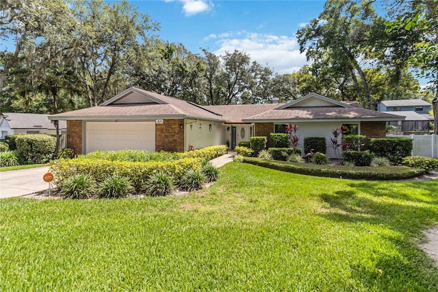 205 Stevenage Dr, Longwood, FL 32779 - single story home with an attached garage, driveway, stone siding, and a shingled roof