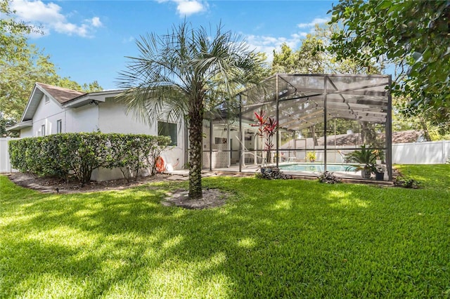 205 Stevenage Dr, Longwood, FL 32779 - back of house featuring stucco siding, a fenced backyard, and glass enclosure