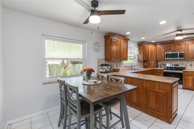 205 Stevenage Dr, Longwood, FL 32779 - kitchen with stainless steel appliances, a ceiling fan, decorative backsplash, a peninsula, and recessed lighting