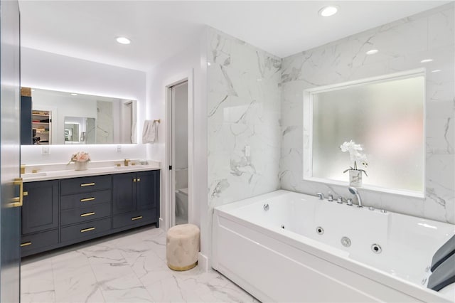 205 Stevenage Dr, Longwood, FL 32779 - bathroom featuring marble look tiles, a whirlpool tub, double vanity, and recessed lighting
