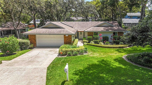 205 Stevenage Dr, Longwood, FL 32779 - ranch-style house featuring stone siding, an attached garage, a front yard, and concrete driveway