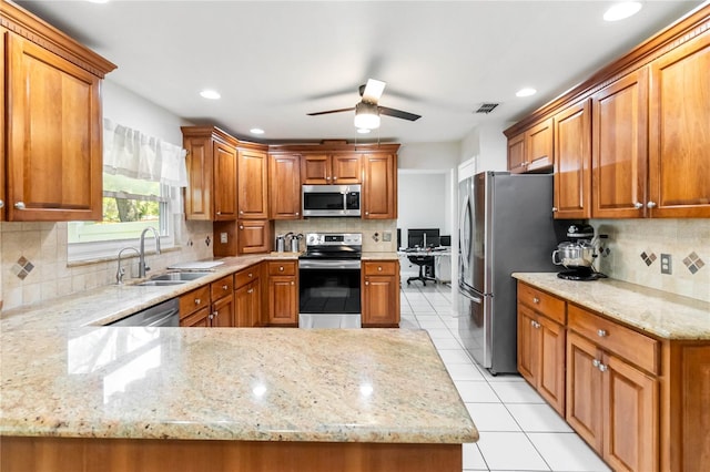205 Stevenage Dr, Longwood, FL 32779 - kitchen featuring stainless steel appliances, backsplash, ceiling fan, light stone countertops, and light tile patterned floors