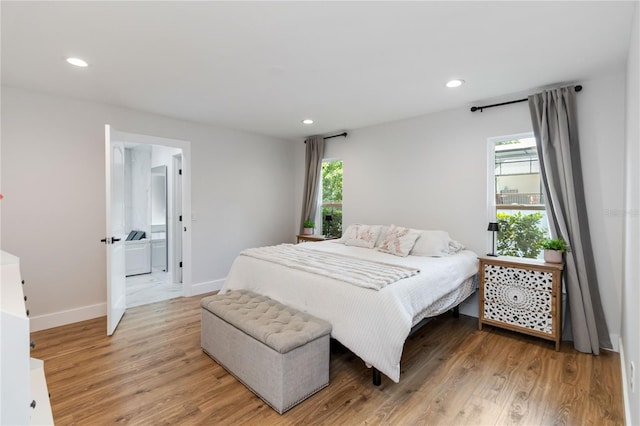 205 Stevenage Dr, Longwood, FL 32779 - bedroom with multiple windows, recessed lighting, light wood finished floors, and connected bathroom