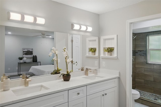 841 Wesson Ct, Casselberry, FL 32707 - full bath with connected bathroom, double vanity, a tile shower, and a ceiling fan