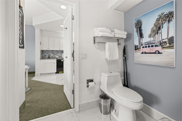 8303 Palm Pkwy Unit 402, Orlando, FL 32836 - bathroom featuring marble look tiles, decorative backsplash, recessed lighting, and vanity