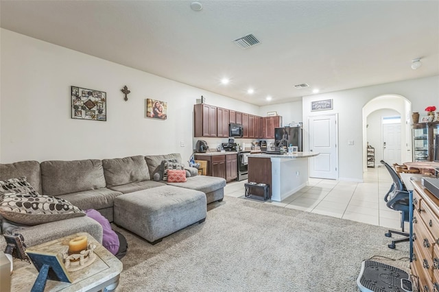 819 Lucent Sands Ct, Brandon, FL 33511 - living room featuring arched walkways, light tile patterned flooring, and recessed lighting